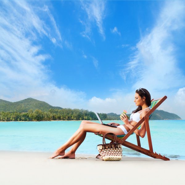 Young, sporty, sexy and beautiful girl in swimsuit resting on exotic beach in summer